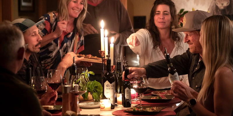 header image of People enjoying nelson olive oil around a table